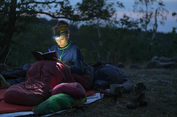 What are the best practices for reducing light pollution while camping in the UK?