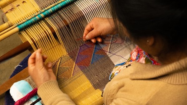 How can you engage in a hands-on experience of traditional British weaving techniques?